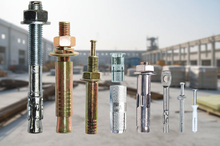 Set of metal bolts and fasteners for concrete with construction site in the background