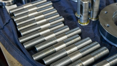 Close-up of double ended studs on blue background