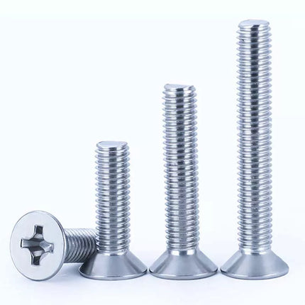 Four metallic screws of different types on a white background