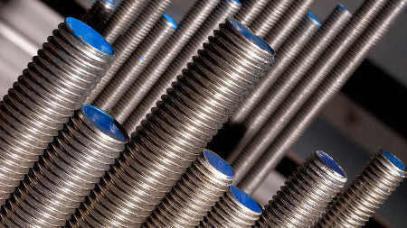 Close-up of threaded rods with blue painted tips