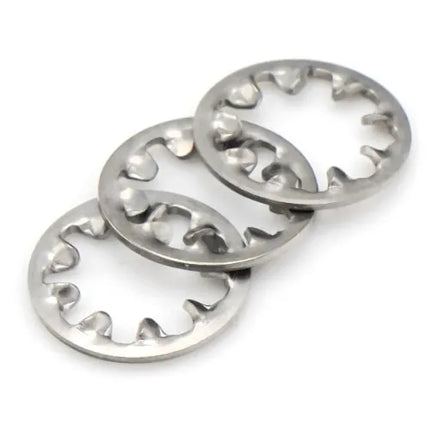 Three metal washers with teeth on a white background